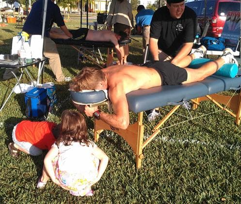 Kyle Cholka giving massages at a community event